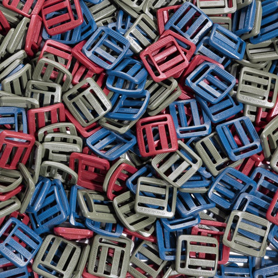 A pile of Shamma Elite Color Buckles in red, blue and green