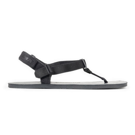 Black leather sandal with a strap on a white background