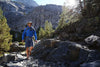 A man hiking through the mountains wearing Shamma Mountain Goats.